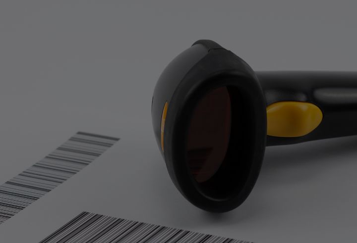Black barcode scanner with yellow button