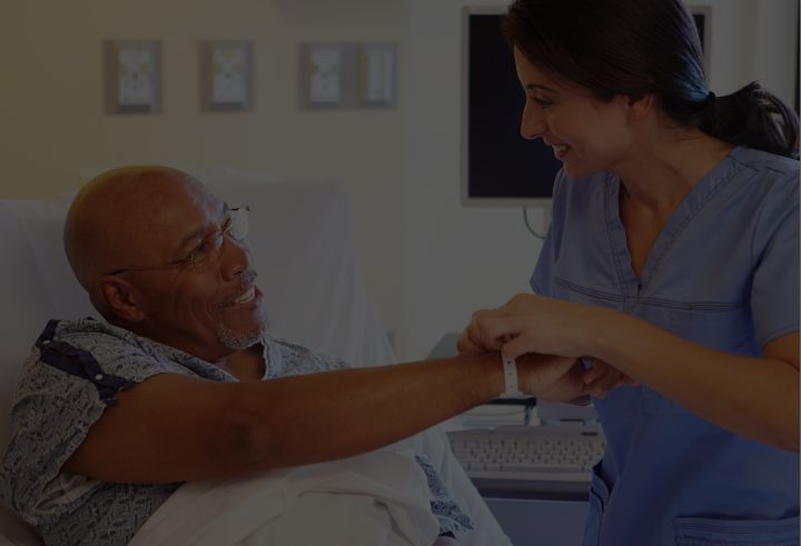 Healthcare professional putting wristband on patient