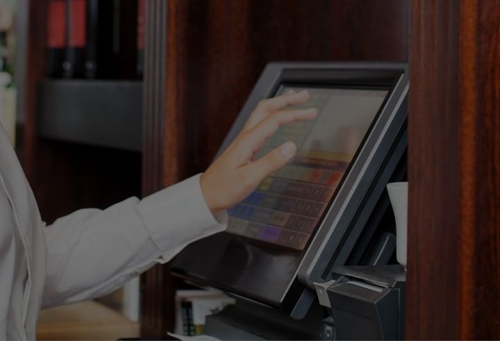 Restaurant worker tapping on EPOS screen