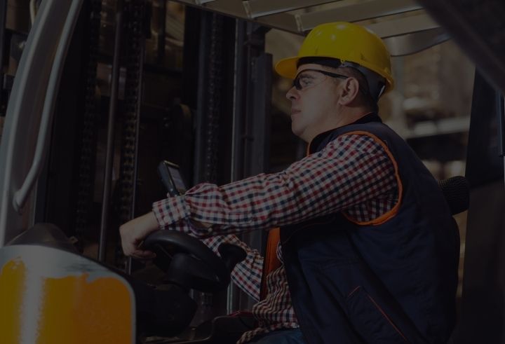 Man in forklift with mobile computer